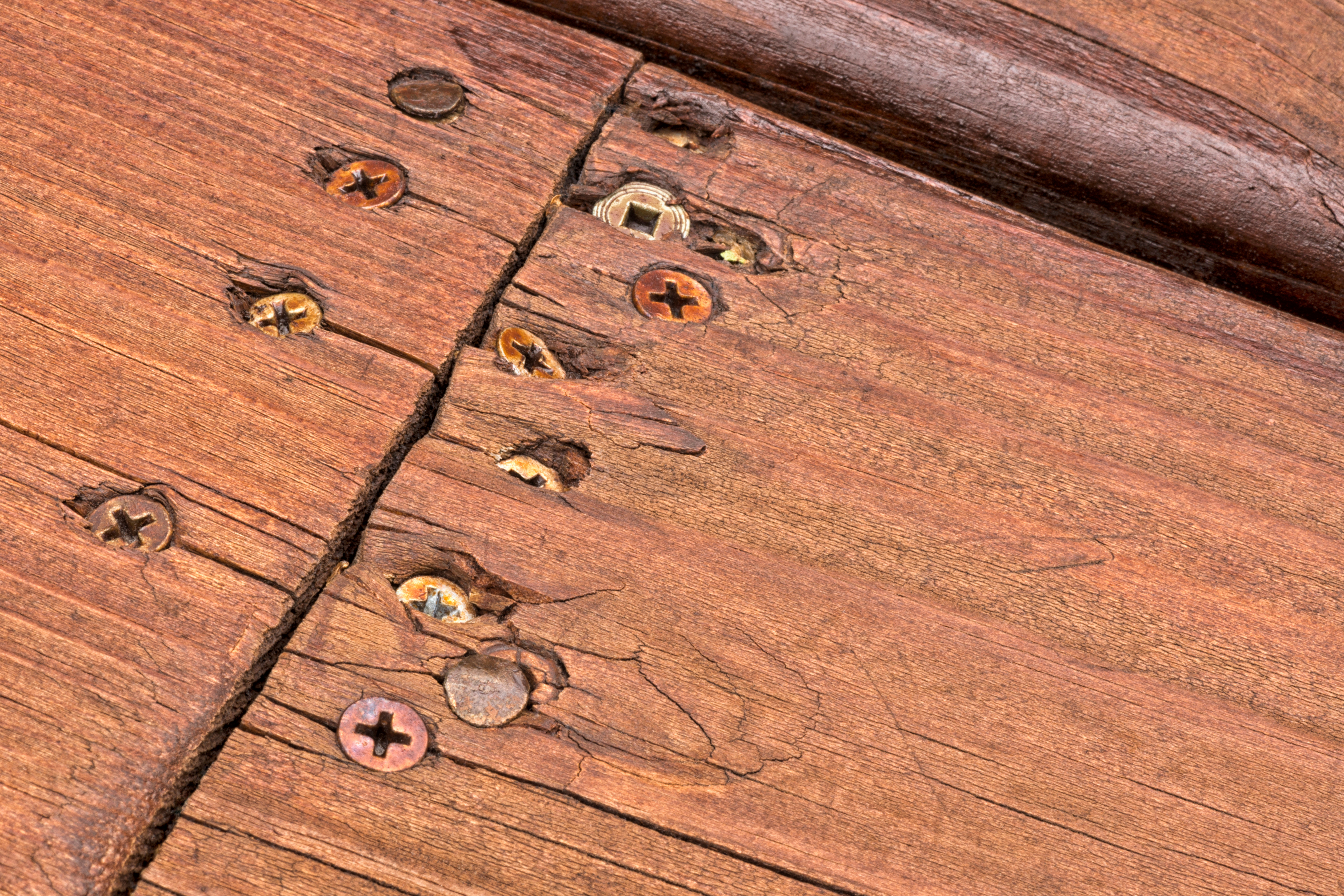 Close-up of sloppy construction and damaged wood — a visual red flag you hired the wrong custom home builder showing poor workmanship.